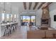 Spacious living room with a stone fireplace and large windows at 14236 E Ranch Rd, Scottsdale, AZ 85262
