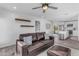 Living room with brown leather couch and kitchen view at 14236 E Ranch Rd, Scottsdale, AZ 85262