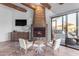 Living area with a stone fireplace and two comfy armchairs at 14236 E Ranch Rd, Scottsdale, AZ 85262
