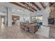Open concept living area with exposed wooden beams and a cozy fireplace at 14236 E Ranch Rd, Scottsdale, AZ 85262