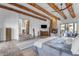 Large main bedroom with wood beams, fireplace, and access to patio at 14236 E Ranch Rd, Scottsdale, AZ 85262
