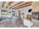 Main bedroom featuring wood beams, fireplace, and relaxing sitting area at 14236 E Ranch Rd, Scottsdale, AZ 85262