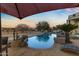 Stunning pool at sunset with lounge chairs and a cactus at 14236 E Ranch Rd, Scottsdale, AZ 85262