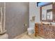 Modern powder room with wood vanity, copper sink, and patterned wall at 14236 E Ranch Rd, Scottsdale, AZ 85262