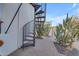 Modern spiral staircase leading to an upper level, near desert landscaping at 14236 E Ranch Rd, Scottsdale, AZ 85262