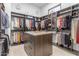 Large walk-in closet with ample hanging space and drawers at 14236 E Ranch Rd, Scottsdale, AZ 85262
