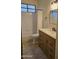 Well-lit bathroom featuring a tile shower-tub, wooden vanity, and modern black hardware at 15720 E Yucca Dr, Fountain Hills, AZ 85268