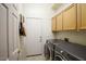 Convenient laundry room with washer, dryer, and ample cabinet space at 15720 E Yucca Dr, Fountain Hills, AZ 85268