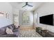 Cozy living room featuring a comfy sofa, flat-screen TV, and stylish decor at 15720 E Yucca Dr, Fountain Hills, AZ 85268