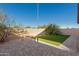 Landscaped backyard with artificial turf and patio at 17912 N 88Th Dr, Peoria, AZ 85382