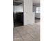 View of kitchen with gray cabinets and tile flooring from dining area at 18202 N Cave Creek Rd # 128, Phoenix, AZ 85032