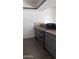 View of kitchen stove and gray cabinets with tile flooring at 18202 N Cave Creek Rd # 128, Phoenix, AZ 85032