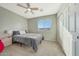 Cozy bedroom with double bed, nightstand, and ceiling fan at 1976 S 172Nd Ln, Goodyear, AZ 85338