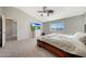 Main bedroom with large bed, TV, and access to another room at 1976 S 172Nd Ln, Goodyear, AZ 85338