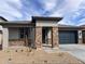 Charming single-story home featuring a stylish brick facade, modern gray accents, and a well-maintained driveway at 20629 N 226Th Ln, Surprise, AZ 85387