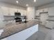 Modern kitchen with white cabinets, granite countertops, stainless steel appliances, and a large center island at 20629 N 226Th Ln, Surprise, AZ 85387