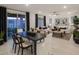 Open concept dining area with a black table and access to the backyard at 20631 N 226Th Ln, Surprise, AZ 85387