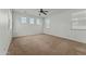 Bright bedroom with ceiling fan and large windows at 21150 W Prospector Way, Buckeye, AZ 85396