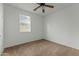 Well-lit bedroom with ceiling fan and window at 21150 W Prospector Way, Buckeye, AZ 85396