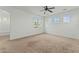 Spacious bedroom with ceiling fan and large windows at 21150 W Prospector Way, Buckeye, AZ 85396
