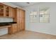 Kitchen with built-in desk, wood cabinets, and granite countertops at 21150 W Prospector Way, Buckeye, AZ 85396