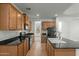 Modern kitchen with wood cabinets, granite counters, and a gas stove at 21150 W Prospector Way, Buckeye, AZ 85396