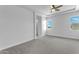 Bright bedroom with ceiling fan, carpet flooring, and window views at 24235 N 194Th Ave, Surprise, AZ 85387