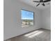 Bedroom with ceiling fan, carpet flooring, and a large window at 24235 N 194Th Ave, Surprise, AZ 85387