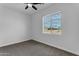Bedroom with ceiling fan, carpet flooring, and a window with a view at 24235 N 194Th Ave, Surprise, AZ 85387