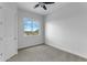 Bedroom with ceiling fan, carpet flooring, and a window with a view at 24235 N 194Th Ave, Surprise, AZ 85387