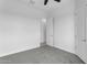 Bedroom with ceiling fan, carpet flooring, and an adjacent door at 24235 N 194Th Ave, Surprise, AZ 85387