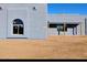 Modern exterior of a newly built house with custom arched window and tan exterior walls at 24235 N 194Th Ave, Surprise, AZ 85387