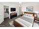 Modern bedroom with a walk-in closet and wood bed frame at 309 E Weldon Ave, Phoenix, AZ 85012
