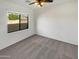 Bright bedroom with ceiling fan and window at 3305 S 122Nd Ln, Tolleson, AZ 85353