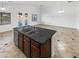 Kitchen island with double sink and granite countertop, overlooking Gathering room at 3305 S 122Nd Ln, Tolleson, AZ 85353