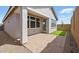 Inviting backyard with a covered patio, neutral colors, and a small patch of artificial turf at 4380 N 203Rd Dr, Buckeye, AZ 85396
