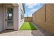 Cozy backyard with artificial turf, paver patio, and privacy wall, perfect for outdoor relaxation and low maintenance at 4380 N 203Rd Dr, Buckeye, AZ 85396