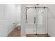 Sleek bathroom featuring modern glass shower, white tile, and fixtures at 4380 N 203Rd Dr, Buckeye, AZ 85396