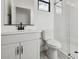 White bathroom featuring patterned tile floors, walk-in shower, and white cabinets at 4380 N 203Rd Dr, Buckeye, AZ 85396