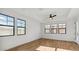 Bright bedroom featuring hardwood floors, large windows and ceiling fan at 4380 N 203Rd Dr, Buckeye, AZ 85396