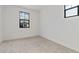 Clean bedroom with neutral carpet, light walls, and bright windows at 4380 N 203Rd Dr, Buckeye, AZ 85396