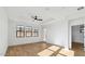 Bright bedroom features hardwood floors, ceiling fan and three large windows at 4380 N 203Rd Dr, Buckeye, AZ 85396