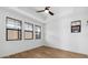 Bedroom with hardwood floors, tray ceiling and multiple bright windows at 4380 N 203Rd Dr, Buckeye, AZ 85396