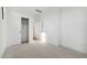 Minimalist bedroom with walk in closet, carpeted floors, and neutral walls at 4380 N 203Rd Dr, Buckeye, AZ 85396