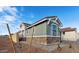Exterior view of home featuring stone accents, neutral colors, and landscaped front yard with blue skies at 4380 N 203Rd Dr, Buckeye, AZ 85396