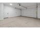 Spacious two-car garage featuring a clean concrete floor and an automatic door opener at 4380 N 203Rd Dr, Buckeye, AZ 85396