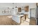 A kitchen featuring an island, wood cabinets, stainless steel appliances, and wood floors at 4380 N 203Rd Dr, Buckeye, AZ 85396