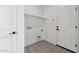 Well-lit laundry room with patterned tile flooring, shelving, and modern hookups at 4380 N 203Rd Dr, Buckeye, AZ 85396