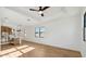 An open space featuring wood floors, recessed lighting, and a view into the kitchen at 4380 N 203Rd Dr, Buckeye, AZ 85396