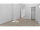 A clean, well-lit bedroom with neutral carpet, an open doorway, and a closet at 4419 N 203Rd Ave, Buckeye, AZ 85396